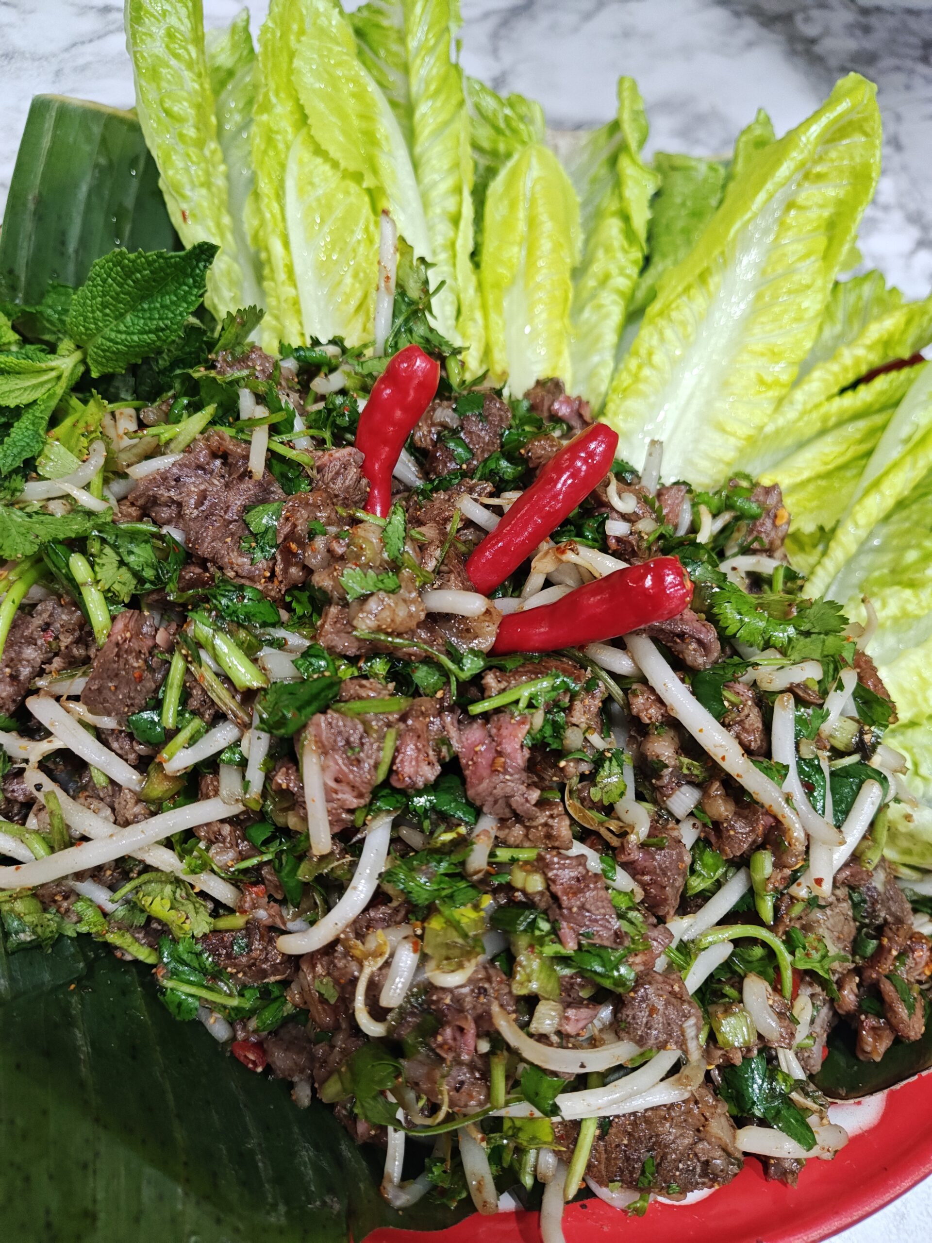 Beef lahp by rice and roots